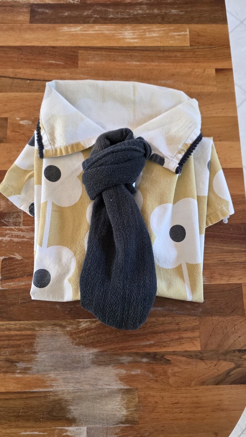 Dish towels folded into a playful shirt and tie